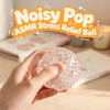 A hand holds a clear, bubbly stress relief ball for ASMR and stress relief.