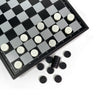A black and white checkered board game with white checkers scattered on the board.