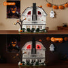 A detailed model of a haunted horror house built from white blocks, featuring spooky decorations and Halloween elements.