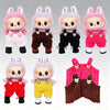 Five labubu plush dolls wearing colorful strap pants in various colors and patterns