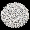 A pile of small white acrylic alphabet letter beads for jewelry making