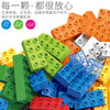 A pile of colorful plastic building blocks in various colors including green, yellow, orange, and blue.