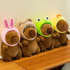 A row of adorable capybara plush toys in various colors including pink, brown, and lime green.