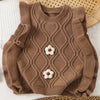 A brown knit sweater vest for girls featuring a flower shape design and ruffled edges.