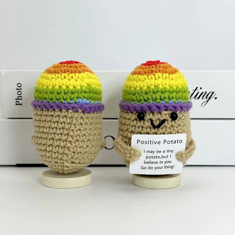 Two handwoven crochet pencil ornaments shaped like potatoes with colorful knitted tops
