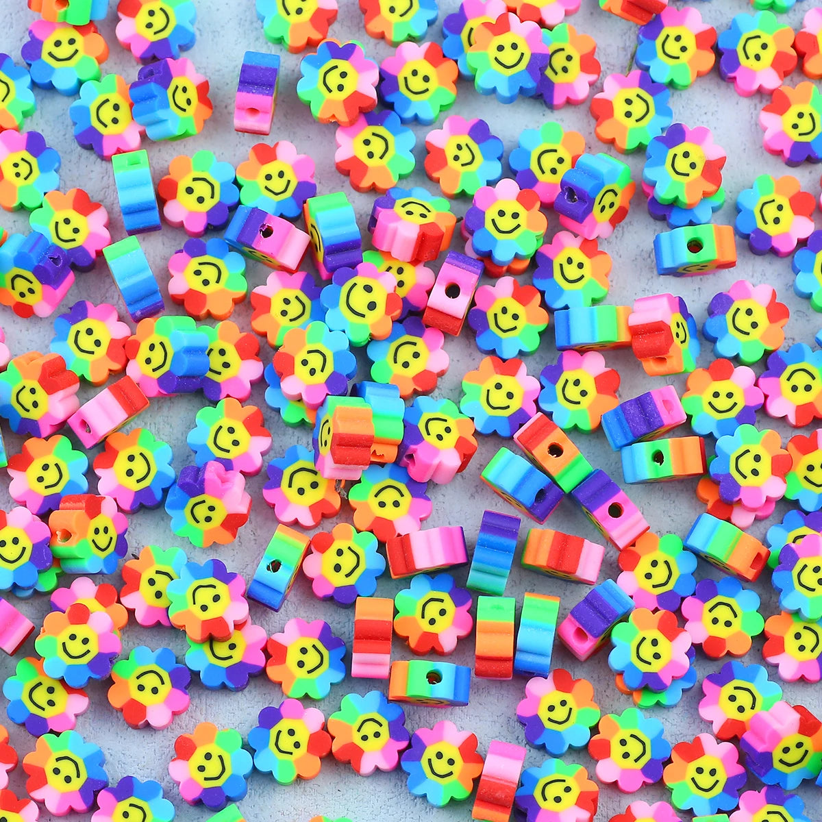 A collection of colorful polymer clay smiling sunflower beads for jewelry making