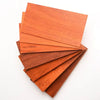 A stack of natural African red rosewood boards showing various shades of reddish-brown wood.