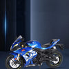 A blue Suzuki Eostar diecast motorcycle model with lights and suspension on a dark background.