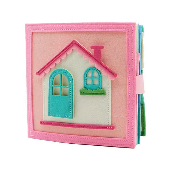A pink felt busy board featuring a cutout house with a blue door and green trim.