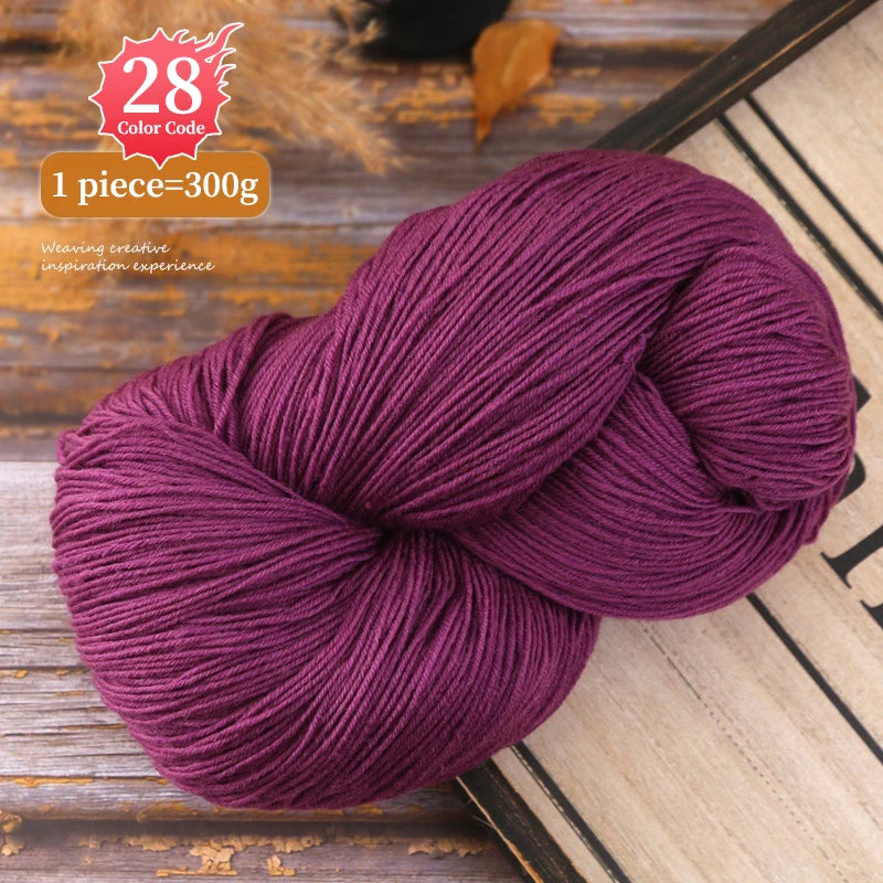 A ball of deep purple yarn is shown on a wooden surface, with a color code label nearby.