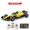 Yellow 1:64 scale RC drift car model with wheels and a controller.