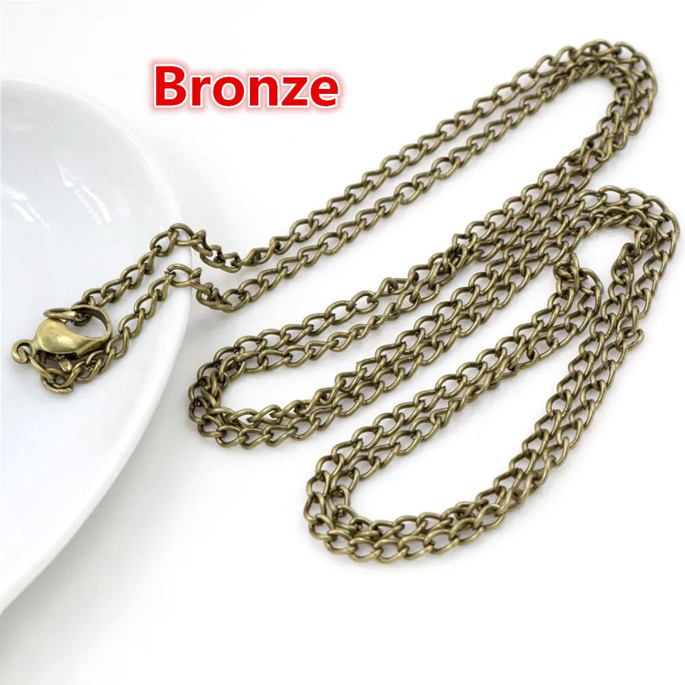 Bronze handmade flattened chain connector for jewelry making displayed on a white surface.