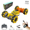 Orange 55A stunt vehicle with remote control and battery shown next to a hand-held watch and USB charging cable