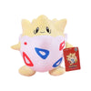 A yellow and white plush doll of Pikachu with red and blue accents, displayed next to its packaging.