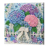 A vibrant painting featuring a bouquet of pink and purple flowers made from various colored pearls and beads on a wooden fram