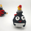 Handmade crochet F-bomb doll with an encouragement card featuring a black body and a red, yellow, and gray head.