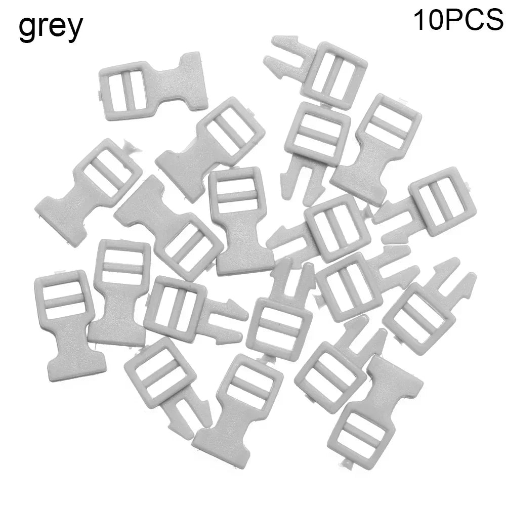 A pile of ten grey mini plastic buckles for DIY crafts and outdoor gear.