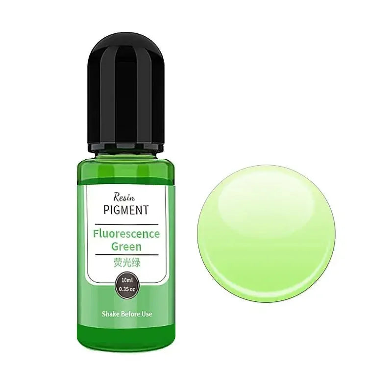 A green glass bottle of Fluorescence Green pigment with a black cap and a circular green disc.