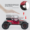 A red four-wheel drive off-road crawler truck is shown with a hand pointing to its features.