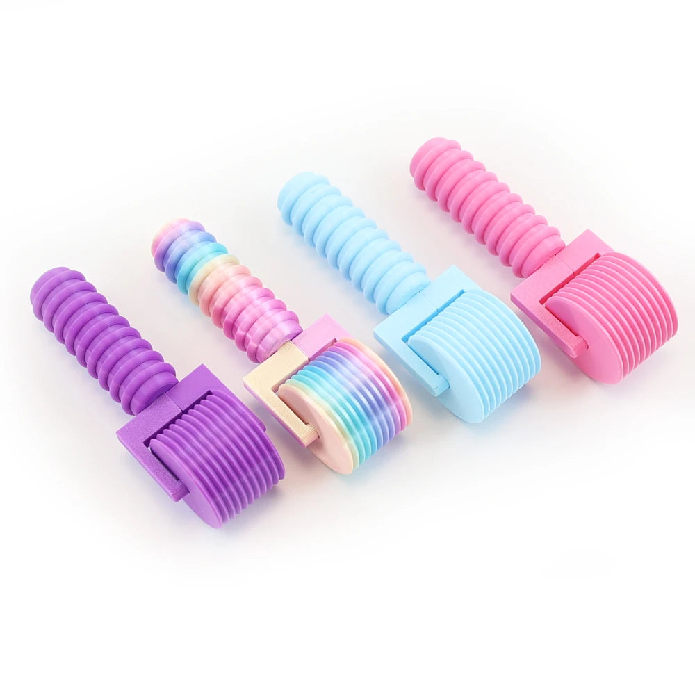 A set of colorful, interchangeable diamond painting rollers with smooth rolling cylinders in purple, pink, and blue.