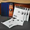 A set of electric guitar strings in a blue box and loose white packaging showing various gauges.