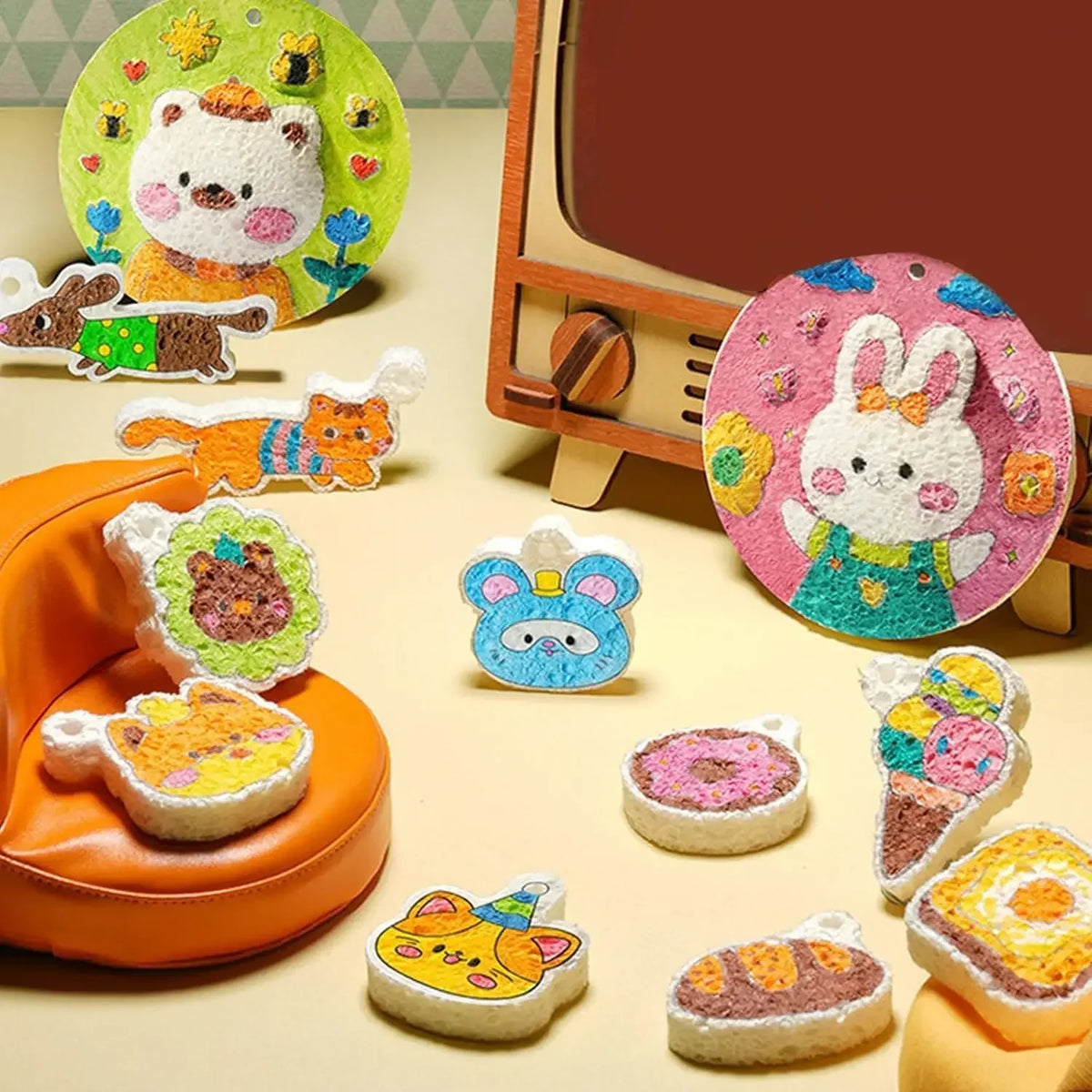 A collection of colorful bubble painting art pieces made from foam paper and markers displayed on a light background.