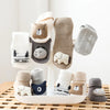 A collection of adorable cartoon non-slip cotton socks for babies and toddlers in various neutral colors.