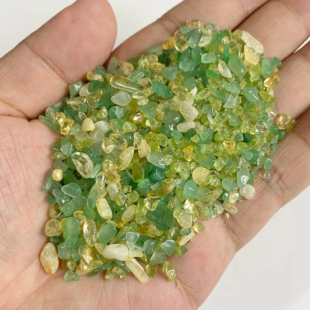 A handful of light green to yellowish natural tumbled stone chips for jewelry making and home decor