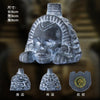 A handcrafted Aztec death whistle made of grey stone, shown from the front, back, and top views.