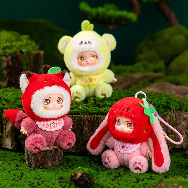 A collection of adorable plush keychains featuring characters resembling pandas and other cute animals set in a mossy outdoor