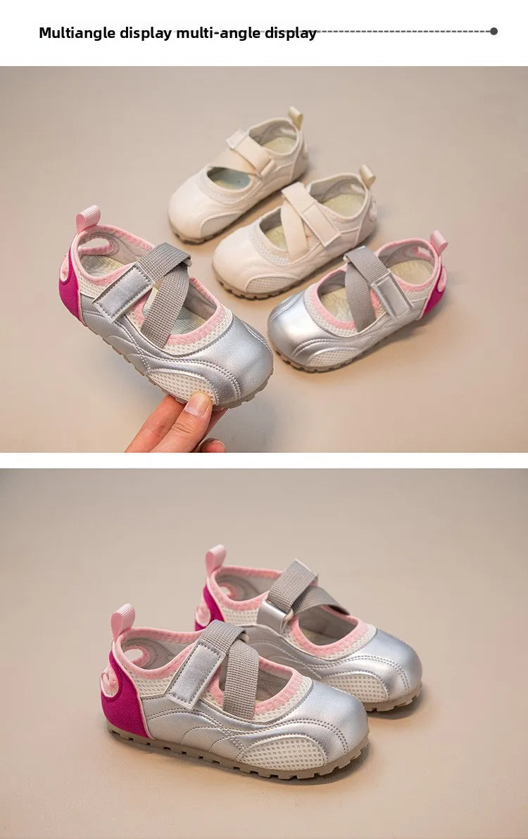 A pair of silver and pink multi-angle display casual slip-on shoes are shown being held by a hand.