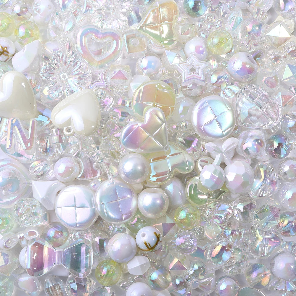 A close-up of colorful iridescent acrylic bow beads and various clear and pearlescent beads for jewelry making