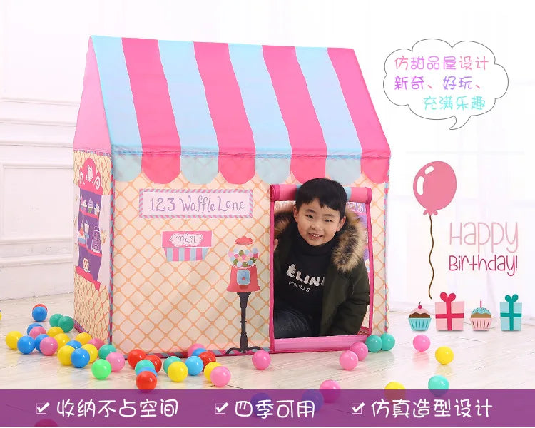 A pink and blue striped foldable kids play tent with a wooden frame and a child inside.