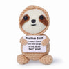 A handmade crochet sloth plush toy with brown and white fur looking forward.
