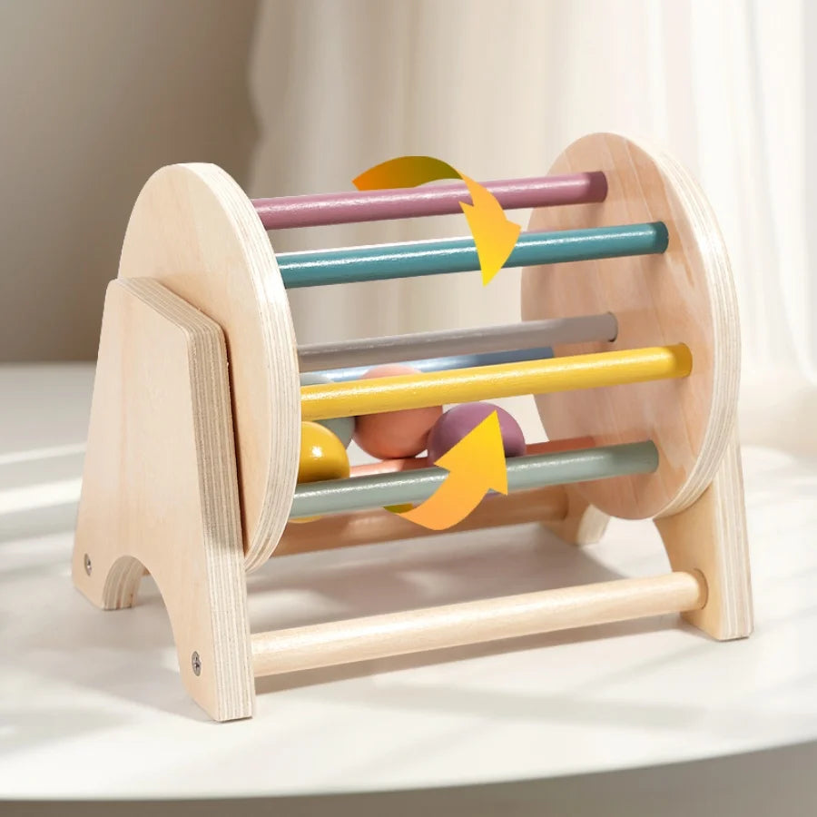 A wooden hand bell with colored rods for soothing and sensory play.