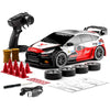 A black RC drift car with red and white decals is shown next to a remote control and tire setup.