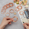 Hands are shown making copper wire coils for DIY projects, with several finished and unfinished coils scattered on a gray sur