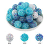 A bowl filled with various blue and white rhinestone resin bayberry beads for jewelry making