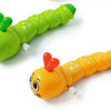 A bright green wind-up caterpillar crawling toy with large eyes and a small green leaf detail.