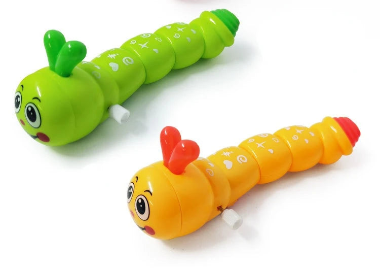 A bright green wind-up caterpillar crawling toy with large eyes and a small green leaf detail.