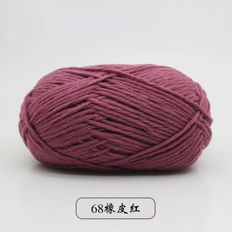 A ball of deep pink pre-dyed milk cotton yarn used for knitting and crochet.