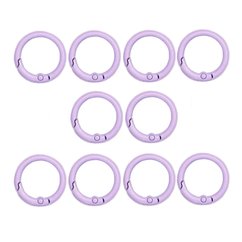 A set of nine purple alloy snap hook keychain clips arranged in a row.