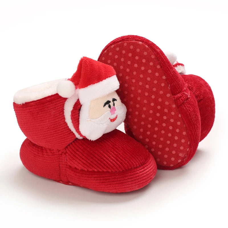 A pair of red felt baby winter boots shaped like Santa Claus, designed for first walkers.