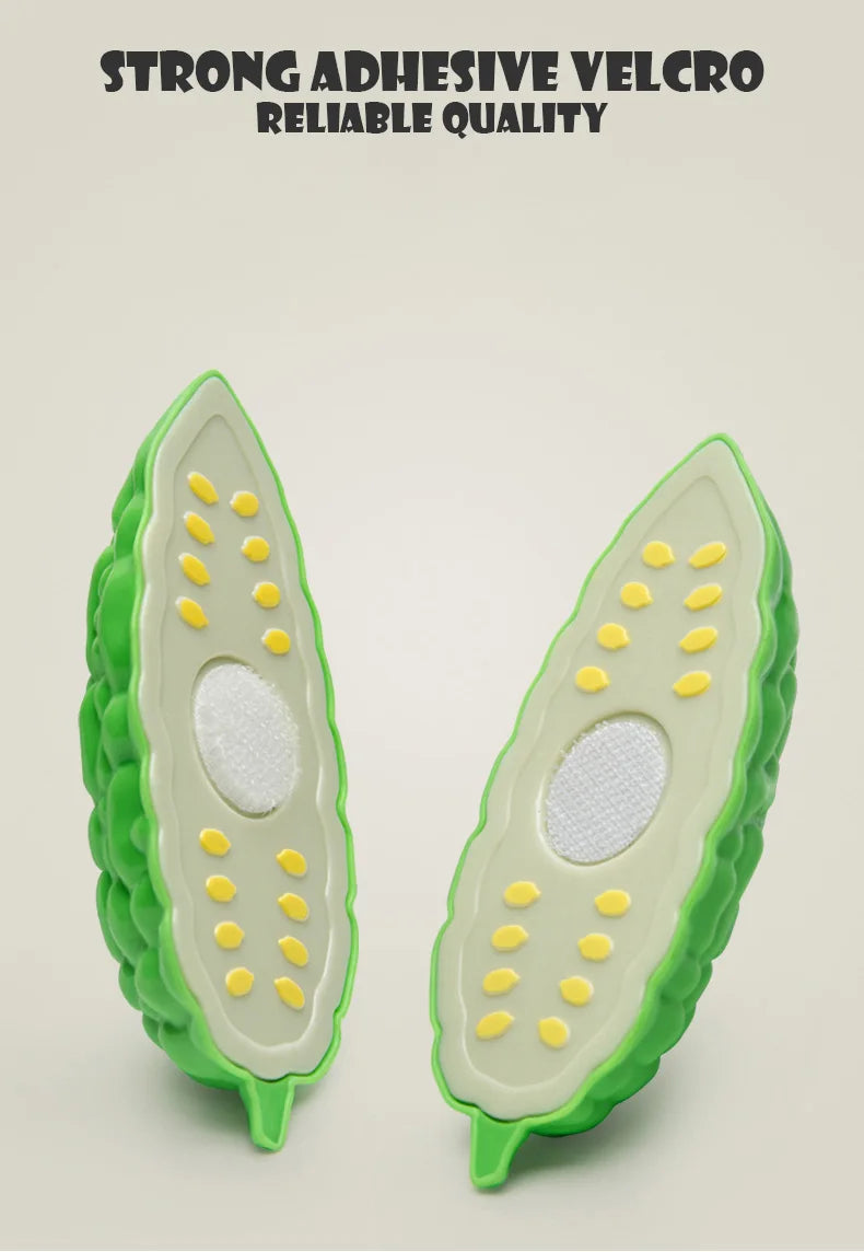 A pair of green pretend play fruit and vegetable cutting set pieces with yellow dots and white filling.