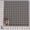 A grid of small gray building blocks with various colored and themed bricks like pizza, cake, and condiment.