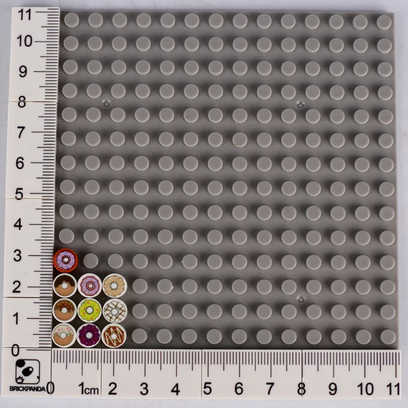 A grid of small gray building blocks with various colored and themed bricks like pizza, cake, and condiment.