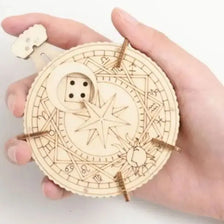 A hand holds a circular wooden puzzle kit with intricate lines and a small wooden piece.