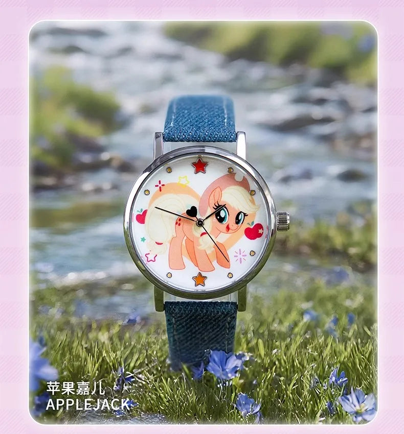 A blue strap watch featuring a My Little Pony Magic Sweetheart design on the face, set against a natural outdoor background.