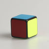 A mini magic cube puzzle with black edges and colored faces, including red and yellow.