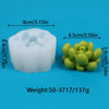 A white silicone mold shaped like a cactus or succulent, next to several green silicone pieces.